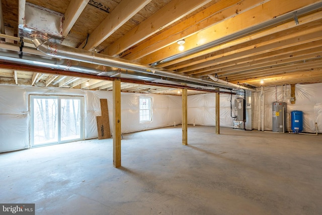 basement featuring electric water heater and heating unit