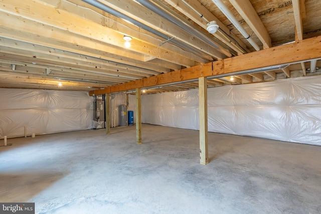 basement with electric water heater and water heater