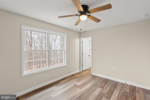 empty room featuring hardwood / wood-style floors and ceiling fan