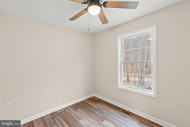 empty room featuring ceiling fan and dark hardwood / wood-style flooring