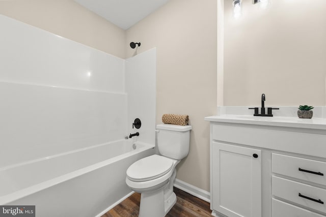 full bathroom with wood-type flooring, vanity, bathing tub / shower combination, and toilet