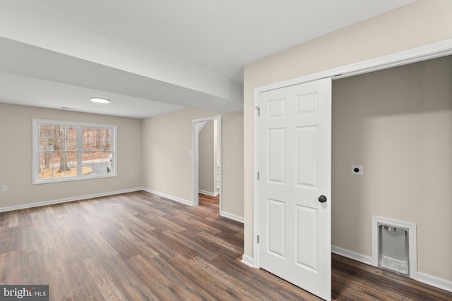 unfurnished bedroom featuring dark hardwood / wood-style flooring and a closet