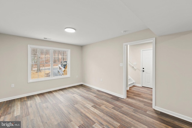 spare room with dark wood-type flooring