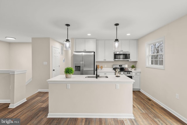 kitchen featuring a center island with sink, white cabinets, stainless steel appliances, and sink