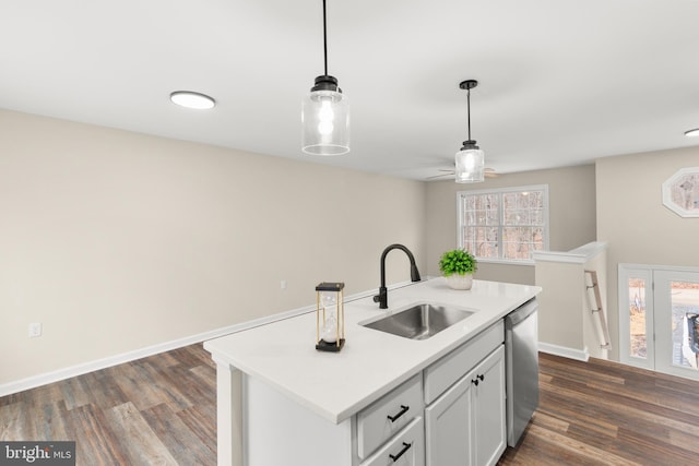 kitchen featuring dishwasher, a healthy amount of sunlight, sink, and an island with sink