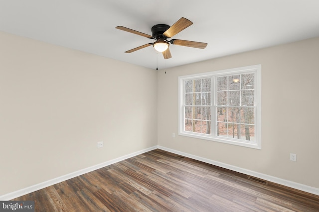 spare room with ceiling fan and dark hardwood / wood-style flooring