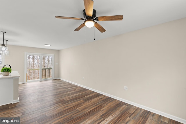 spare room featuring ceiling fan and dark hardwood / wood-style flooring