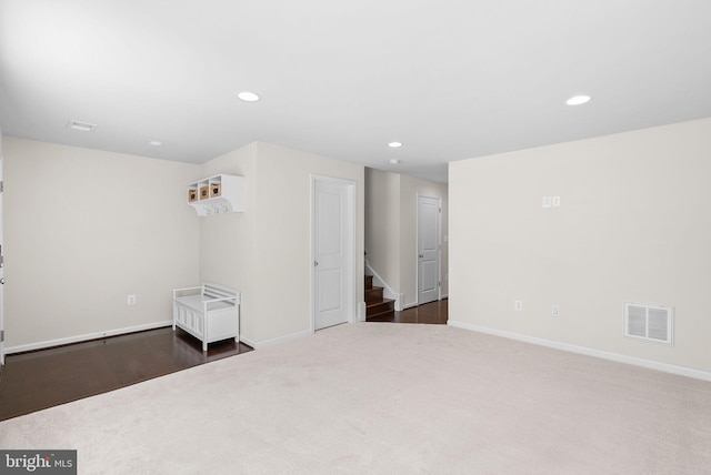 empty room with dark colored carpet