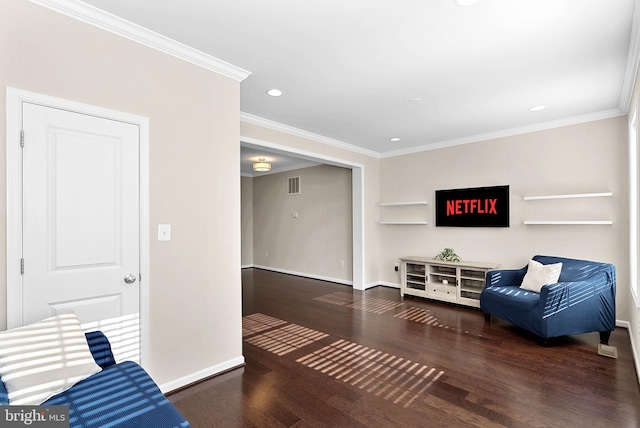 sitting room with ornamental molding and dark hardwood / wood-style floors