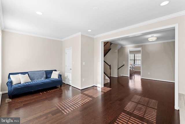 living area with dark hardwood / wood-style flooring and crown molding