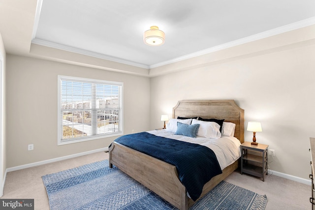 bedroom with crown molding, carpet, and a tray ceiling