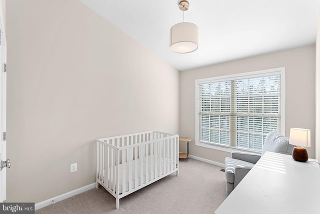 bedroom with a crib and carpet flooring