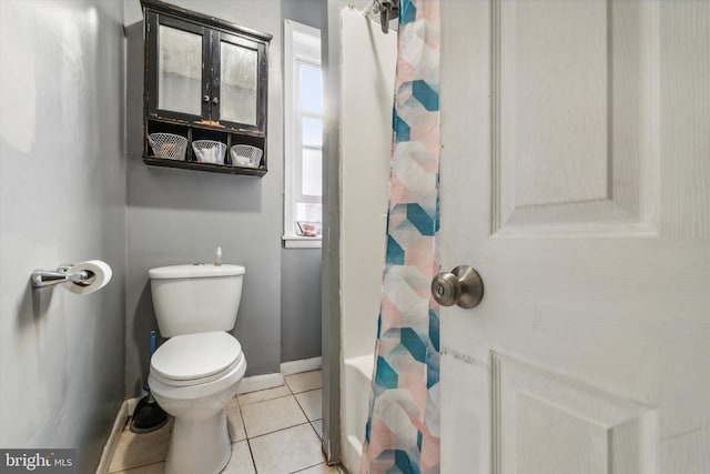 bathroom with toilet, tile patterned floors, and a shower with shower curtain