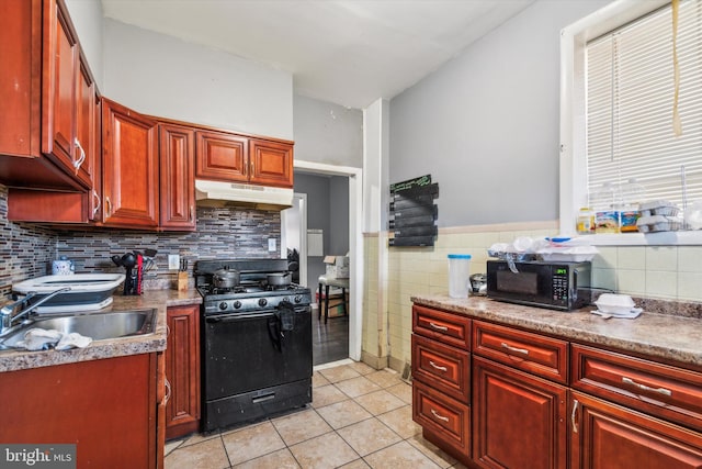 kitchen with sink, black appliances, and light tile patterned floors