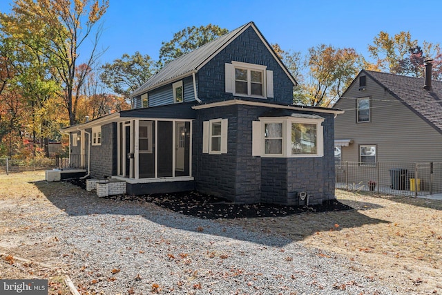 back of house with a sunroom