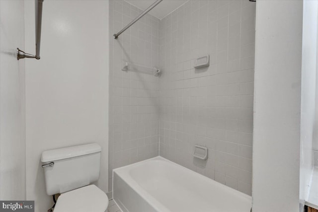 full bathroom featuring toilet, tiled shower / bath combo, and vanity