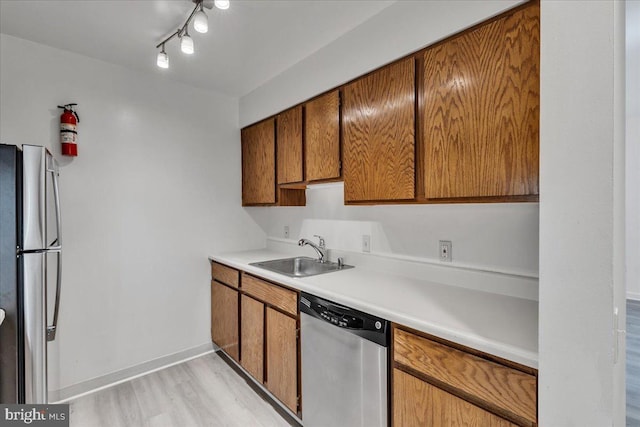 kitchen featuring light hardwood / wood-style floors, stainless steel appliances, and sink