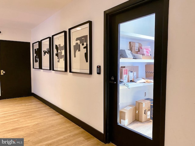 corridor with light hardwood / wood-style flooring