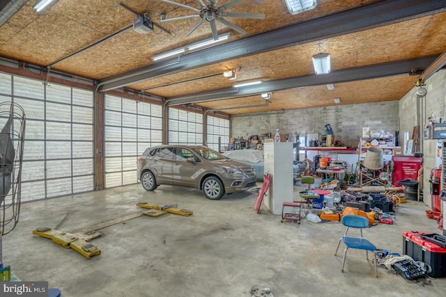 garage with a garage door opener and ceiling fan