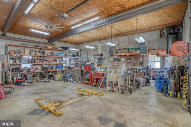 garage with a workshop area and ceiling fan