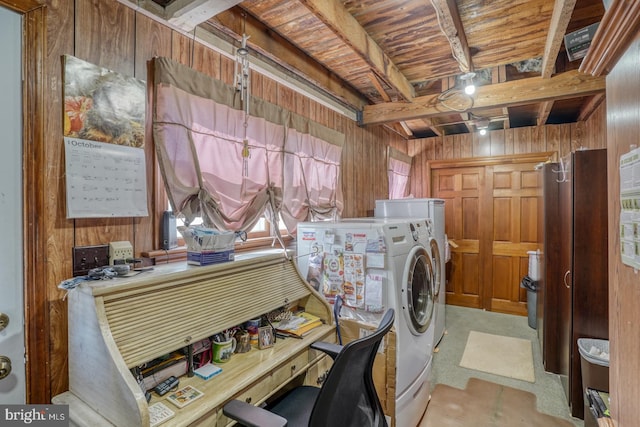 washroom featuring wooden walls and separate washer and dryer