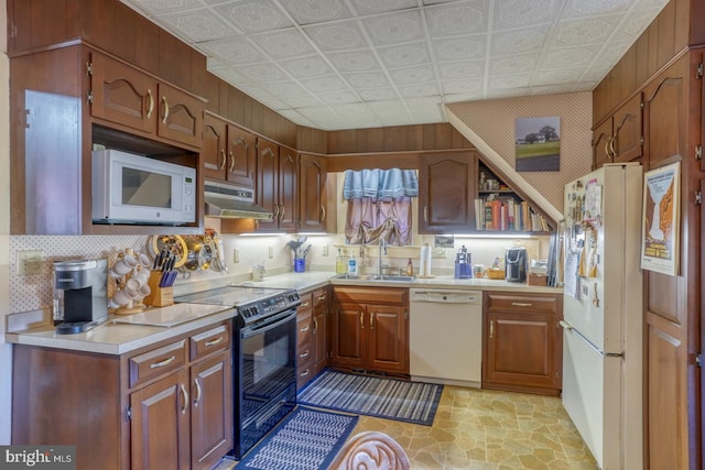 kitchen with sink and white appliances