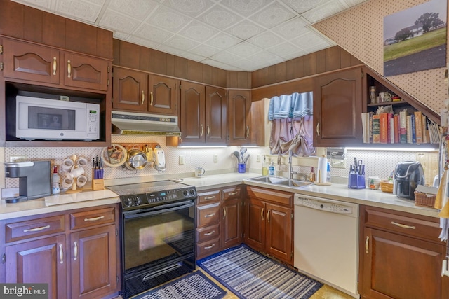 kitchen featuring white appliances and sink