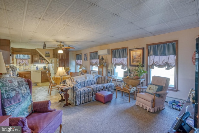 living room featuring a wall mounted AC, ceiling fan, and a wealth of natural light