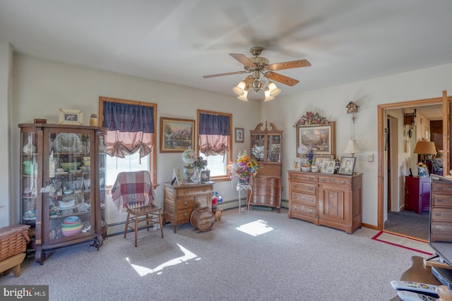 misc room with a baseboard heating unit, light colored carpet, and ceiling fan