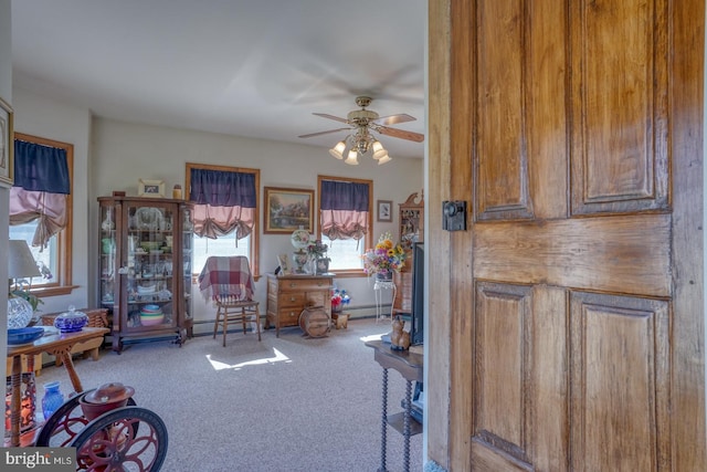 misc room featuring ceiling fan, carpet, and a baseboard heating unit