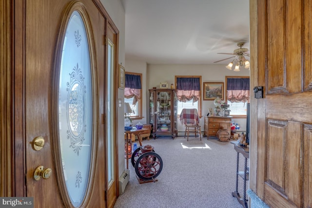 entrance foyer with carpet flooring and ceiling fan