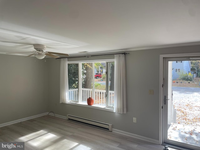 empty room featuring light wood-type flooring, baseboard heating, and ceiling fan