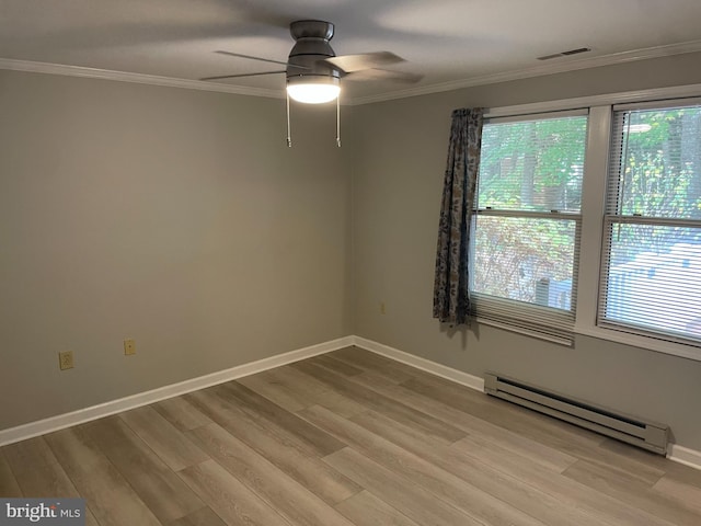 spare room with a baseboard radiator, crown molding, light hardwood / wood-style floors, and ceiling fan