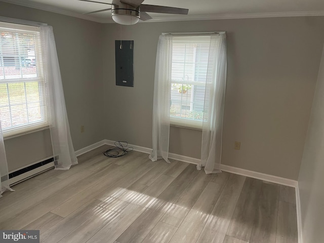 unfurnished room featuring electric panel, a baseboard radiator, ceiling fan, light hardwood / wood-style flooring, and crown molding