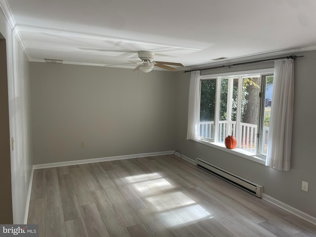 spare room with light hardwood / wood-style flooring, a baseboard heating unit, ceiling fan, and crown molding