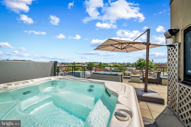 view of swimming pool featuring a hot tub