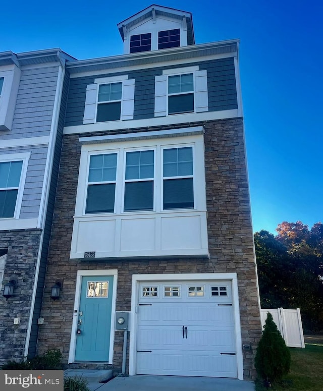 townhome / multi-family property featuring a garage