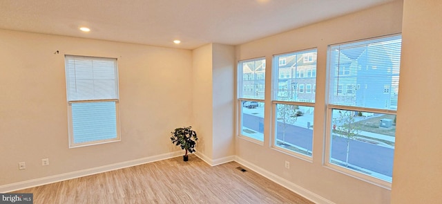 spare room featuring light wood-type flooring