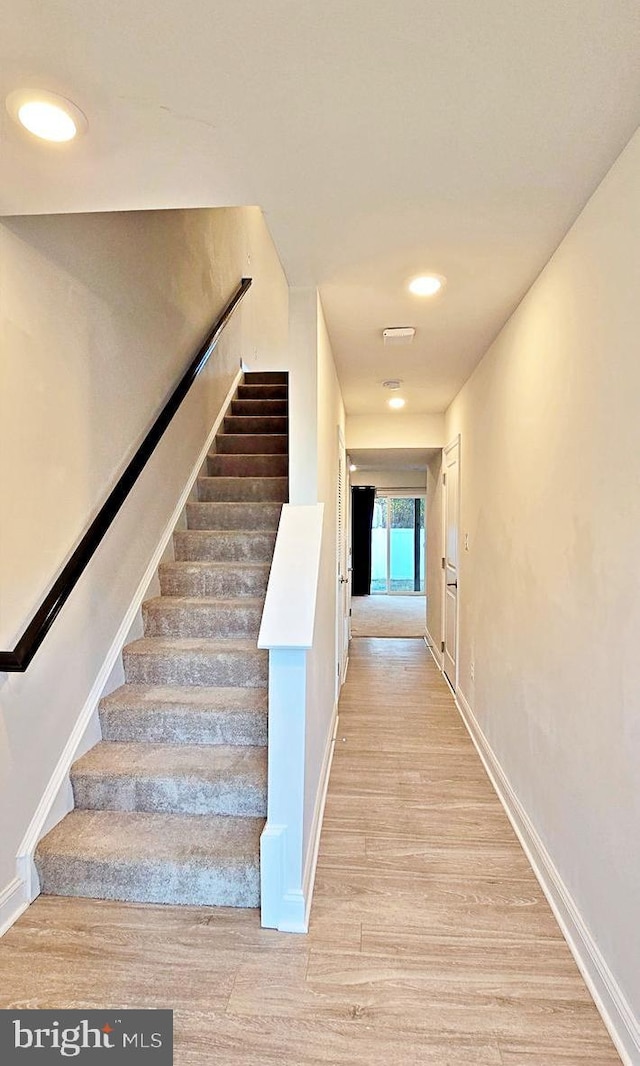 stairs with wood-type flooring