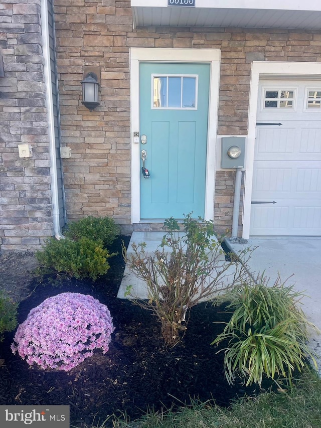 doorway to property featuring a garage