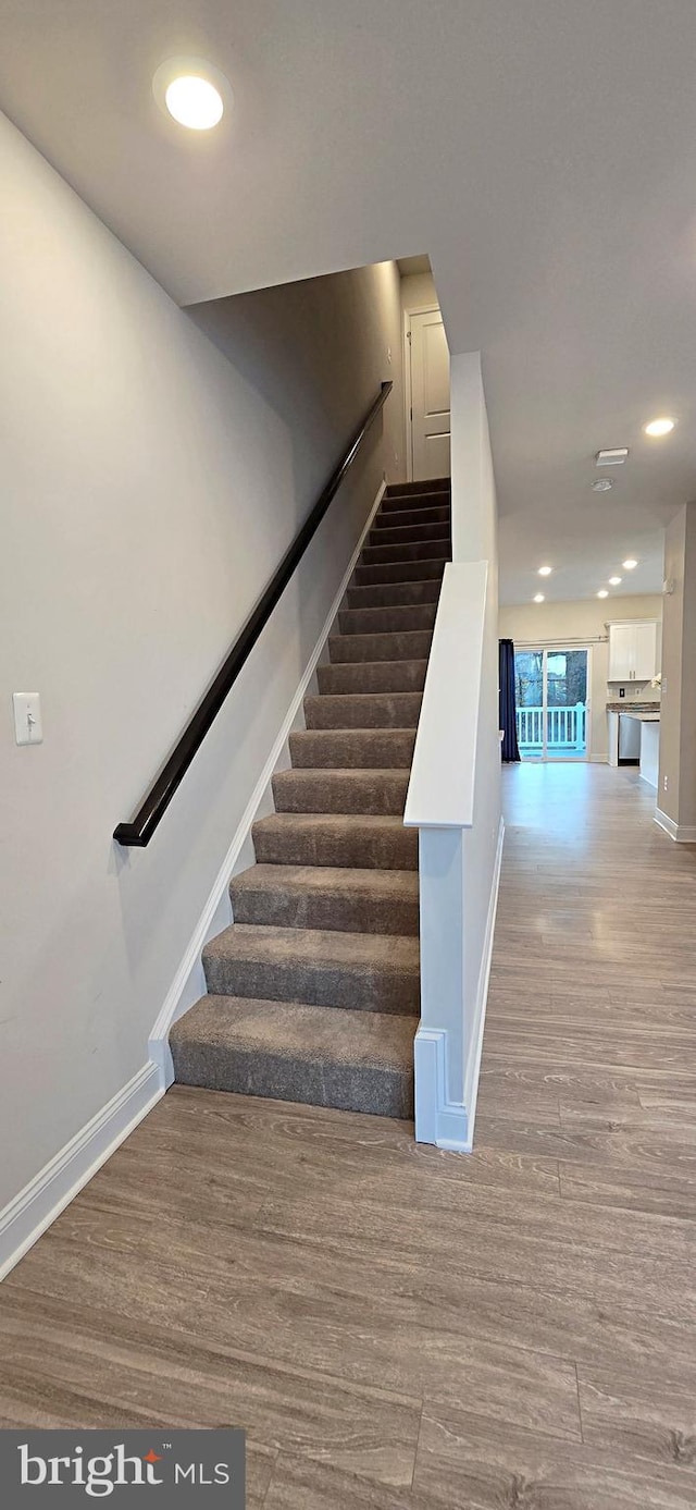 staircase featuring hardwood / wood-style floors