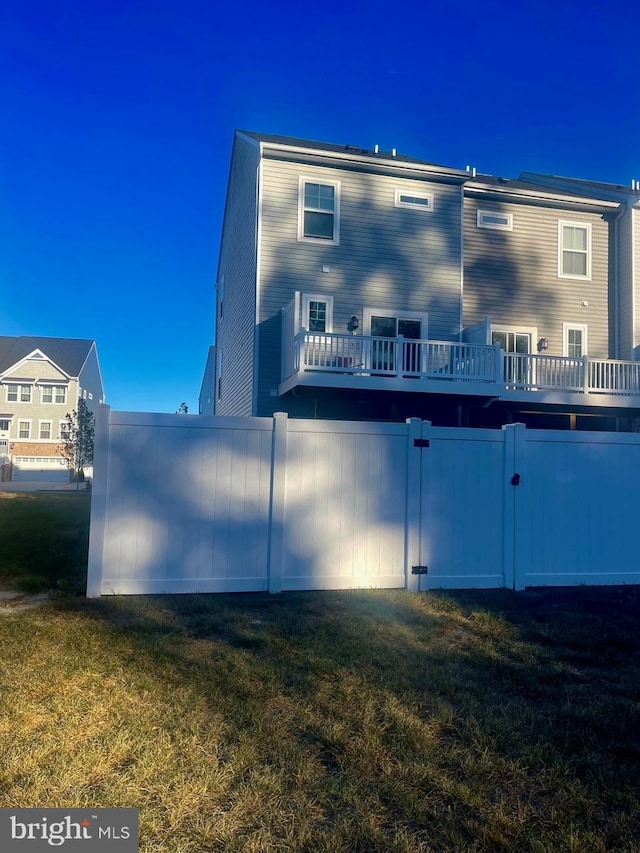 rear view of property featuring a yard