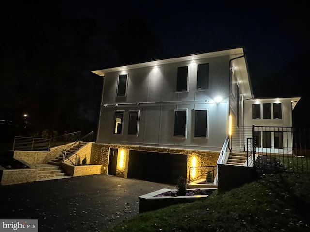 back house at twilight with a garage