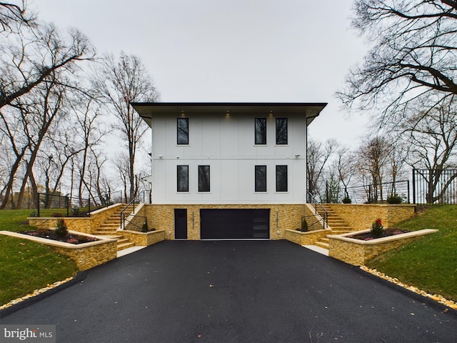 5005 Ravensworth Rd, Annandale, VA 22003 - view of side of property with stairs, an attached garage, and driveway