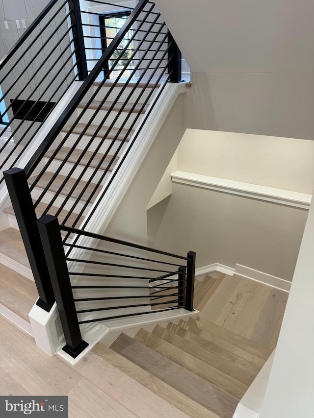 stairs with hardwood / wood-style floors