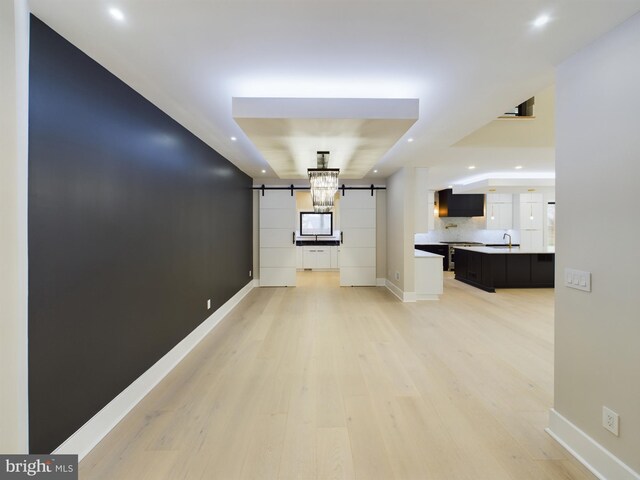 5005 Ravensworth Rd, Annandale, VA 22003 - corridor featuring a barn door, recessed lighting, light wood finished floors, and baseboards