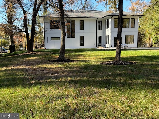 rear view of house with a lawn