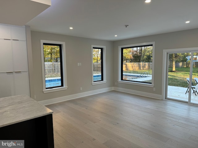 unfurnished dining area with light wood-type flooring