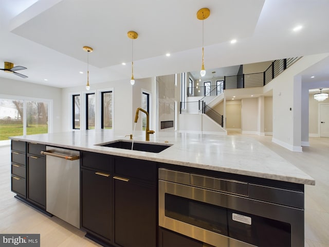 5005 Ravensworth Rd, Annandale, VA 22003 - kitchen with open floor plan, stainless steel appliances, a sink, decorative light fixtures, and light stone countertops