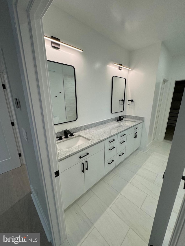 bathroom featuring tile patterned flooring and vanity